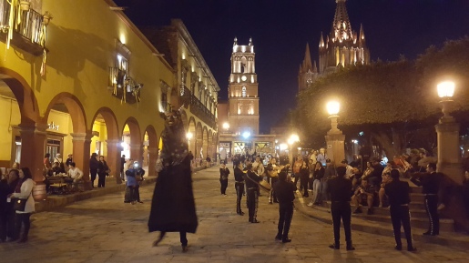 Family-friendly square even at night, with costumed animators and musicians. San Miguel de Allende. Author photo, February 2017.